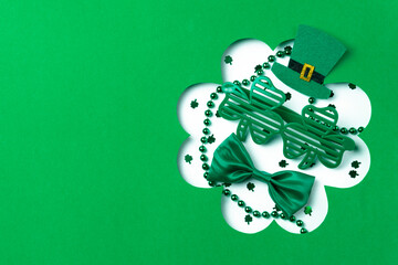 St. Patrick's Day accessories, including a green bow tie, shamrock glasses, beads, and a leprechaun...