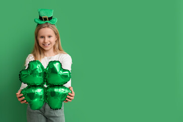 Cute little girl in leprechaun hat with air balloon in shape of clover on green background. St....