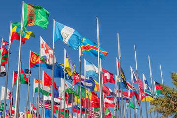 Many world's countries national flags waving on the wind, with Turkmen, Argentinian, Ethiopian and Congolese banners in the foreground, Doha, Qatar