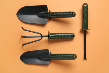 Set of gardening tools on orange background