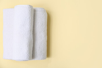 Clean soft towels on yellow background