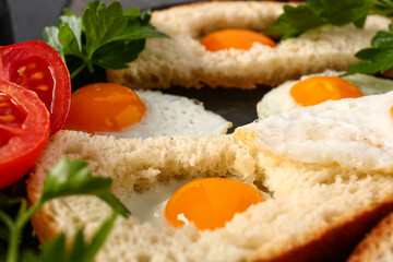 Tasty fried quail eggs with bread and parsley, closeup