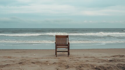 Solitude by the Sea: A Wooden Chair on a Sandy Beach