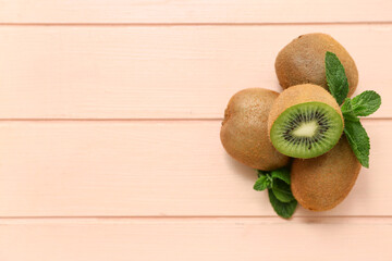 Fresh kiwi and mint on pink wooden background