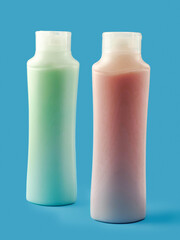 Two plastic bottles or containers with red and green color liquid soap. Ocean blue background. Health and beauty product. Skin and body care. Cosmetic industry.