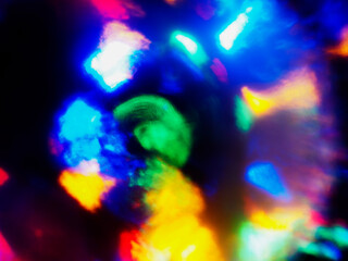 A colorful, blurry background with a rainbow of colors. The colors are bright and vibrant, creating a sense of energy and excitement. Abstract design wall paper. Cinematic light effect.