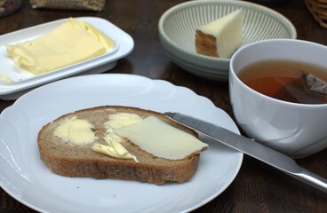 breakfast with bread, butter and tea on the table