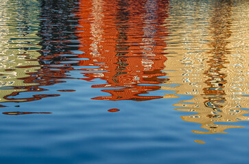 Reflection of colorful houses in the Nidelva river in Trondheim, Norway