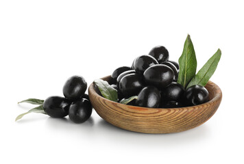 Wooden bowl with tasty black olives and leaves on white background