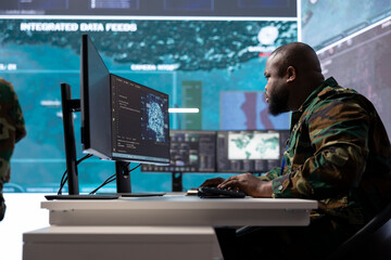 IT professional gathering real time intelligence from radar systems in military control tower,...