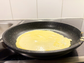Stack of Thin Homemade Crepes with Golden Butter Glaze. High quality photo A delicious stack of thin, golden crepes with a buttery glaze, freshly made and served on a white plate. These homemade