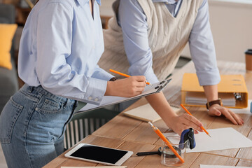 Young business women negotiating at table in office, closeup