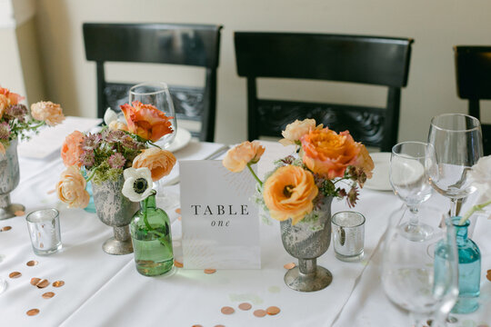 Elegant table setting with floral arrangements and charming decor for a special event in a bright indoor space