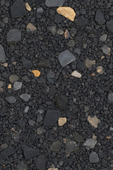 Fototapeta premium Textured black gravel with various stones and pebbles