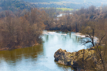 view to the twisted river rushing among forest on coast