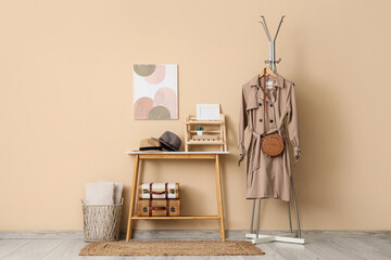 Coffee table and hanger with coat in interior of hallway