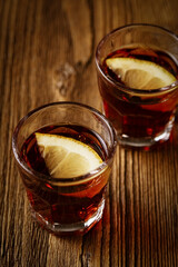 whiskey, dark rum or cognac in short glasses on a wooden table, strong alcohol