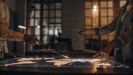 A dynamic view of a holographic world map with interactive geographic data points being manipulated by a team of analysts enhancing their decisionmaking during a strategy meeting.