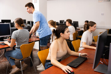 Fototapeta premium Teenager girl using computer during computer sciene lesson in school.