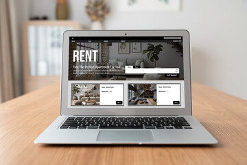 Fototapeta premium Online real estate rental search snugly on computer. House home or apartment rental website online.