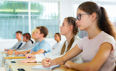Students listening task for exam in the classroom