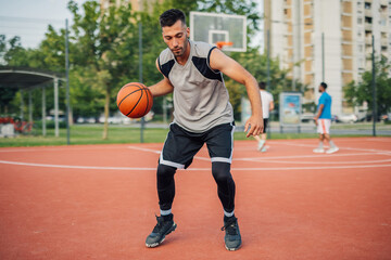 Fototapeta premium Basketball player dribbling ball on court during a game