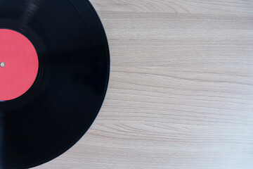 Vintage vinyl record on wooden surface with copy space