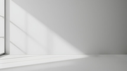 Obraz premium Minimalist interior with sunlight streaming through a window, casting shadows on a blank wall