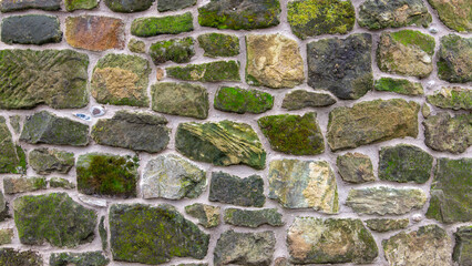 A beautiful renovated stone wall covered in lichen