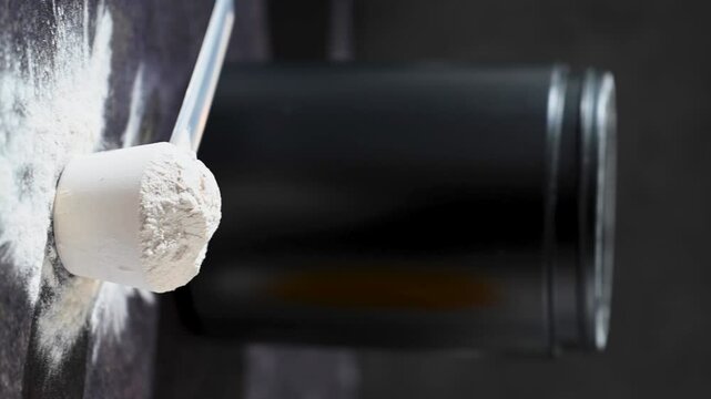 Amino acid food supplement, creatine powder in a measuring scoop, Sports nutrition 