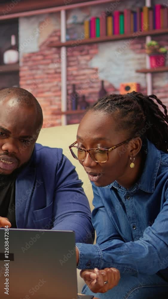 Poster freelancer couple doing research by reading articles and data driven papers at home, collecting info