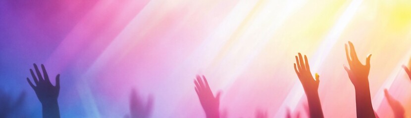 Silhouetted hands raised high against a vibrant, colorful background.
