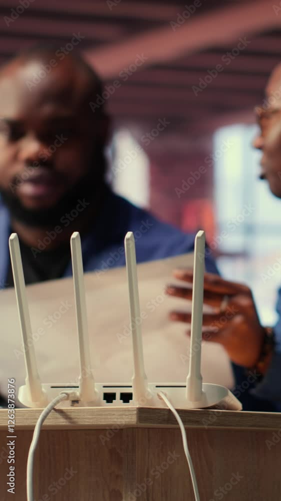 Poster black irritated man and woman rebooting their wireless router and checking network settings, feeling