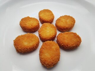 Seven Fried Chicken Nuggets on White Plate