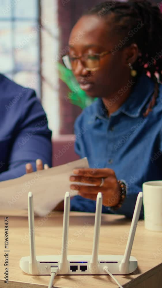 Poster black irritated man and woman rebooting their wireless router and checking network settings, feeling