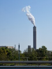 The smoke coming from the industrial chimney is a symbol of climate change and pollution and shows that temperature targets are not being met.