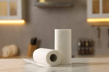 Rolls of paper towels on white marble table in kitchen