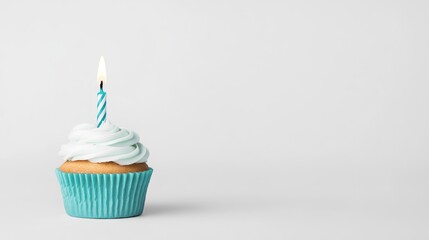 A beautifully frosted cupcake with a blue candle, set against a minimalist white background