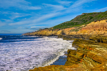 2024-01-26 THE ROCKY SHORELINE WITH FOAMY WATER COMING ASHORE AT POINT LOMA CALIFORNIA NEAR SAN DIEGO