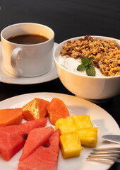 A Healthy Breakfast featuring an array of Fruits accompanied by freshly brewed Coffee