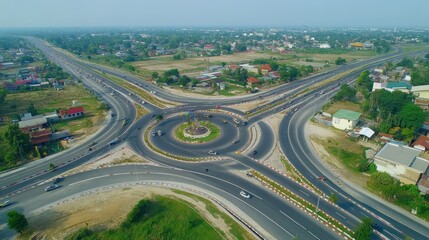 Aerial view of a busy roundabout with multiple roads and surrounding residential areas.