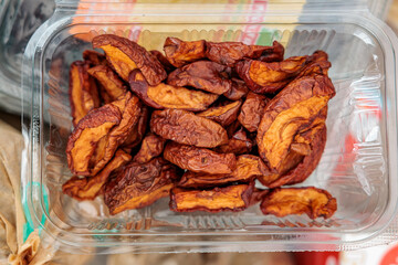 Top view of dried apple slices in plastic container