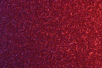 A red background with glittery red and purple dots