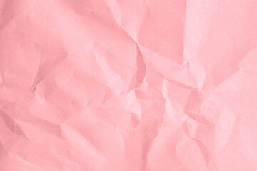 Crumpled pink paper texture with folds and creases