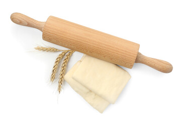 Fresh dough, rolling pin and spikes isolated on white, top view