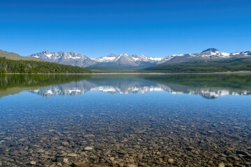 Fototapeta premium Crystal Clear Lake Reflecting Snow Capped Mountains