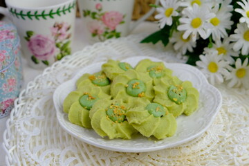 Popular cookies called in green known as pistachio in Malaysia during celebration of Eid Mubarak (Hari Raya) on white background.