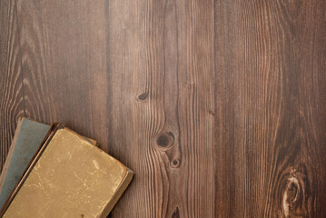 Vintage books on wooden background from above. Flat lay, top view.