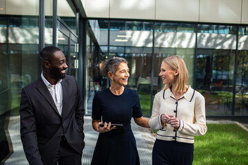 Business professionals having a discussion in modern office lounge