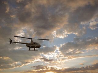 Robinson Helicopter Flys Across Sunset